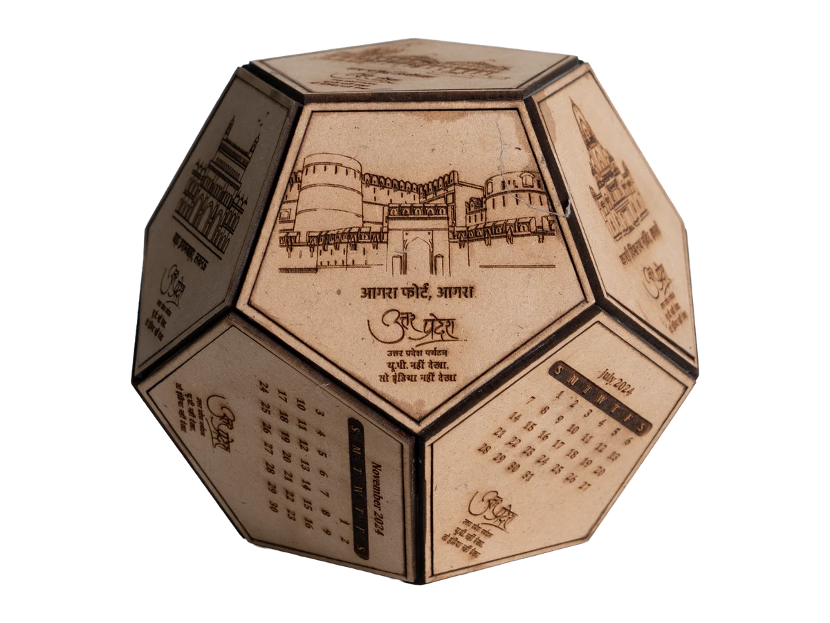 Multi-face desktop calendar with illustrated panels and date grids.