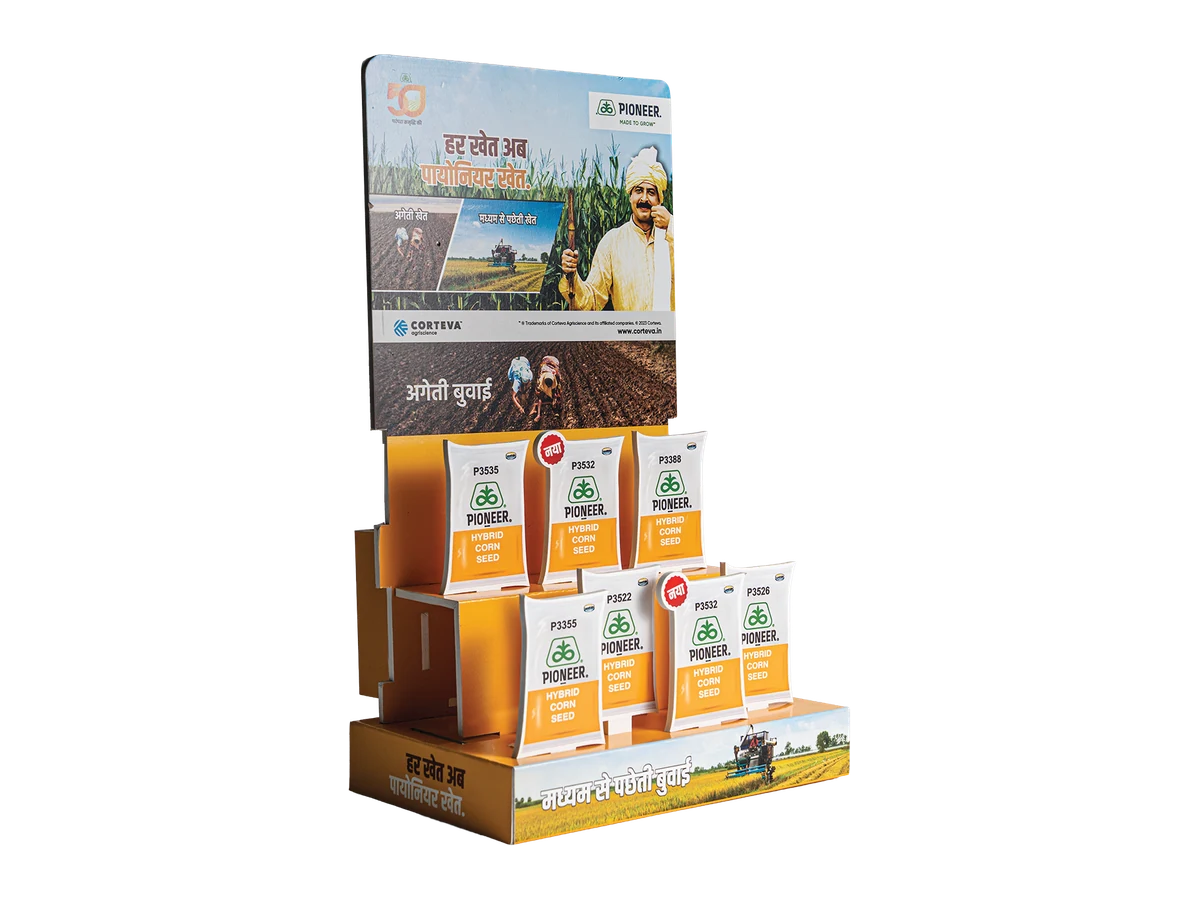 Three-quarter view of a freestanding product display with tiered pockets and a printed header.