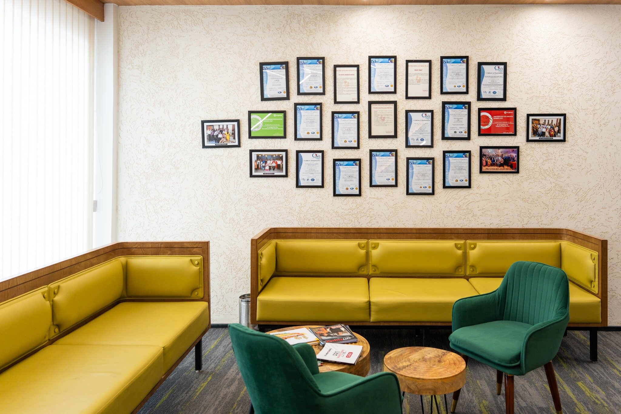 Contemporary PPML office lounge with framed records displayed on the wall.